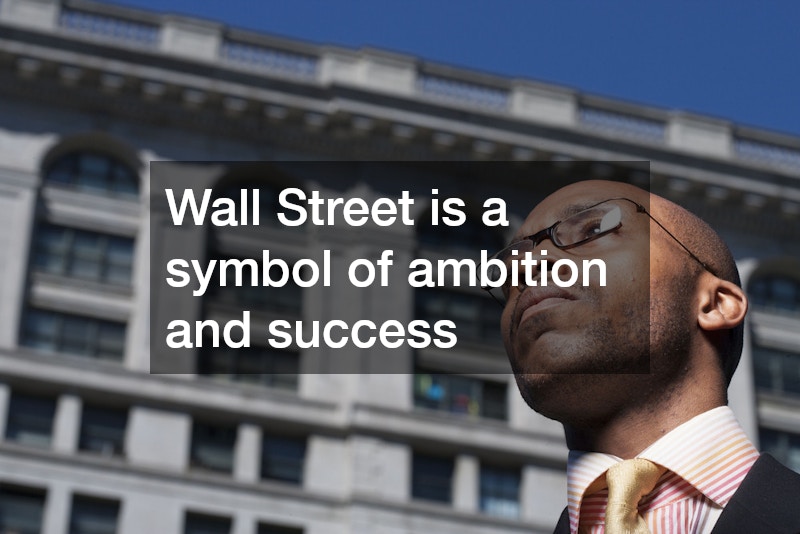 man wearing glasses on wall street